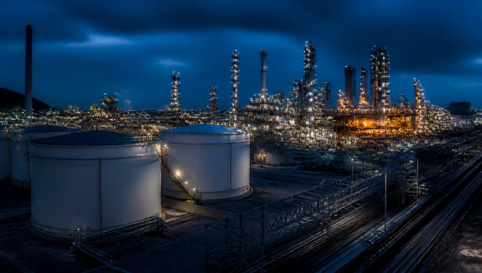Petrochemical storage tanks and processing plant at dusk